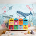 Close-up detail of marine wallpaper with blue whales, pink jellyfish, and underwater coral garden
