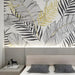 Modern nursery interior with tropical line art wallpaper showing black white botanical pattern and gold fern accents
