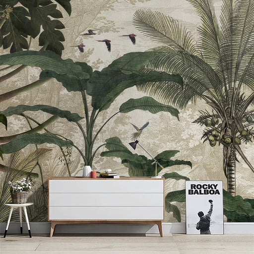 Vintage tropical jungle mural wallpaper with parrots, palm fronds, and banana leaves in muted green and beige tones
