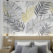 Close-up detail of gold accent ferns and line art palm leaves pattern on tropical botanical wallpaper
