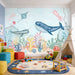 Watercolor ocean mural wallpaper featuring whales, jellyfish, stingray, and coral reef for children's room
